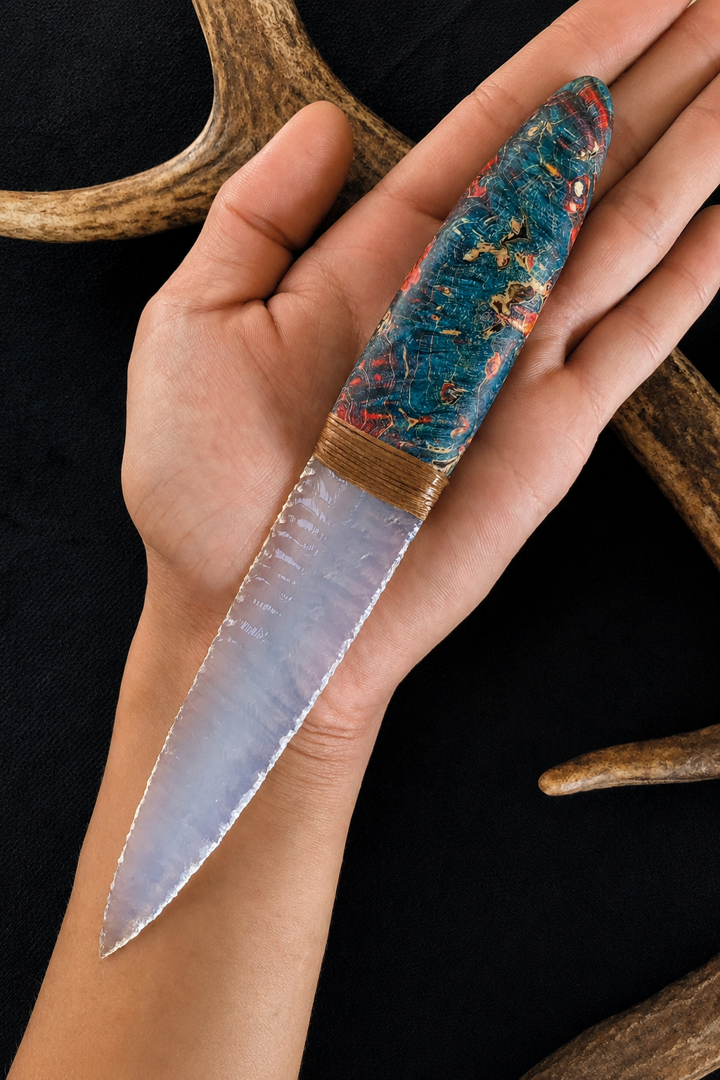 Transparent broad-blade display knife held to show its scale